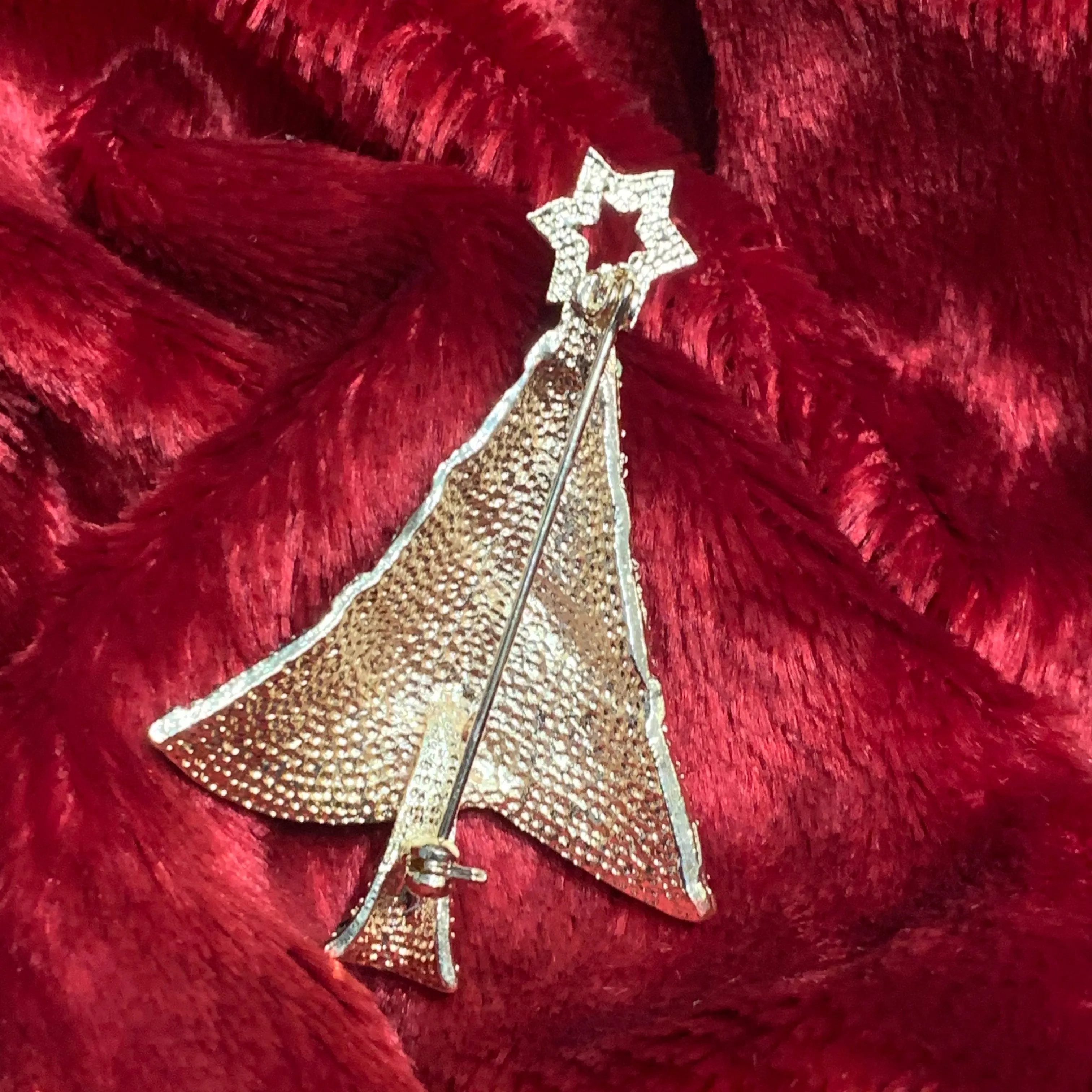 Multi coloured Christmas tree brooch with a star in gold tone.