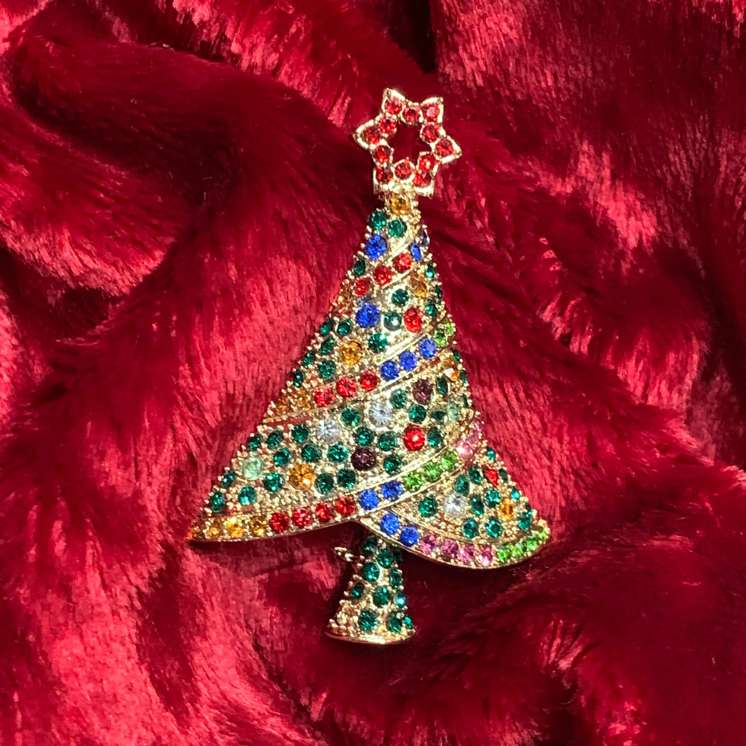 Multi coloured Christmas tree brooch with a star in gold tone.