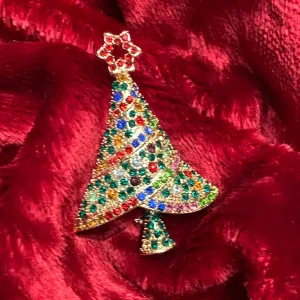 Multi coloured Christmas tree brooch with a star in gold tone.